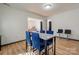 Bright dining area with marble table and blue chairs, offering a view into the living room at 710 W Elm St, Shelby, NC 28150