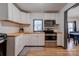 Kitchen with white cabinets, wood countertops, and stainless steel appliances at 710 W Elm St, Shelby, NC 28150