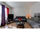 Living room with sectional sofa, coffee table, and large TV at 710 W Elm St, Shelby, NC 28150