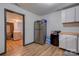 Kitchen with stainless steel refrigerator and view into laundry room at 710 W Elm St, Shelby, NC 28150