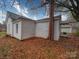 White house exterior with brick chimney, surrounded by autumn leaves at 804 S Jackson St, Salisbury, NC 28144