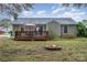 Backyard features a deck, fire pit, and view of the house at 8342 Kapplewood Ct, Charlotte, NC 28226