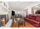 Living room with fireplace, hardwood floors, and red leather seating at 8342 Kapplewood Ct, Charlotte, NC 28226