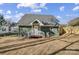 Charming cottage with gray siding, white trim, and small deck at 102 S Liberty St, Gastonia, NC 28052