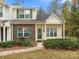 Brick and vinyl townhouse with green shutters and landscaping at 5153 Magnolia Tree Ln, Charlotte, NC 28215