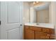 Bathroom with wood vanity and a large mirror at 5682 Stafford Rd, Charlotte, NC 28215