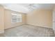 Bright bedroom featuring a window and ceiling fan at 5682 Stafford Rd, Charlotte, NC 28215