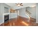 Spacious living room with hardwood floors, fireplace, and stairs at 5682 Stafford Rd, Charlotte, NC 28215