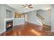 Living room with hardwood floors, fireplace, and staircase at 5682 Stafford Rd, Charlotte, NC 28215