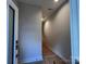 View of the entryway with gray walls and a staircase at 1419 Collier Walk Aly # Csw0208, Charlotte, NC 28205