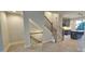 Modern staircase with metal railing and a view of the kitchen and living area at 1419 Collier Walk Aly # Csw0208, Charlotte, NC 28205