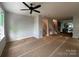 Living room with ceiling fan, and a view towards the kitchen and staircase at 1425 Collier Walk Aly # Csw0211, Charlotte, NC 28205