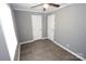 Bedroom with gray walls, ceiling fan, wood-look flooring, and double closets at 192 Allen Pond Rd, Wadesboro, NC 28170