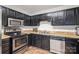 Kitchen with stainless steel appliances and dark wood cabinets at 314 Echo Ave, Kannapolis, NC 28081