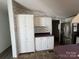 White kitchen cabinets and a decorative backsplash at 36245 Nugget Rd # 2, New London, NC 28127
