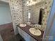 Double vanity bathroom with a patterned wallpaper at 36245 Nugget Rd # 2, New London, NC 28127