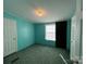 Bright bedroom with teal walls and carpet flooring at 36245 Nugget Rd # 2, New London, NC 28127