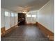 Living room with stone fireplace, wood flooring and shutters at 36245 Nugget Rd # 2, New London, NC 28127