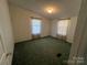 Bright bedroom with two windows and green carpeting at 36245 Nugget Rd # 2, New London, NC 28127