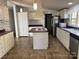 Kitchen with white cabinets, tile flooring, and an island at 36245 Nugget Rd # 2, New London, NC 28127