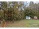 Spacious backyard with detached shed and wooded area at 9009 Quail Roost Dr, Waxhaw, NC 28173