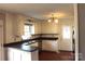 L-shaped kitchen with white cabinets, dark countertops, and door at 1572 W Lakewood Dr # 19, Rock Hill, SC 29732