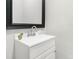 Small bathroom with white vanity and black framed mirror at 3635 Tryon Courthouse Rd, Cherryville, NC 28021