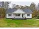 Modern farmhouse exterior with a covered porch and landscaping at 106 Pinecrest Dr, Shelby, NC 28152