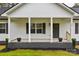 Front porch view of a charming farmhouse with gray accents at 106 Pinecrest Dr, Shelby, NC 28152