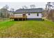 Modern farmhouse exterior with a large deck and grassy backyard at 106 Pinecrest Dr, Shelby, NC 28152