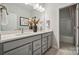 Double vanity bathroom with gray cabinets and a shower/tub combo at 1186 Lost Cove Rd, Indian Land, SC 29707