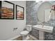 Stylish powder room with patterned tile and a pedestal sink at 1186 Lost Cove Rd, Indian Land, SC 29707