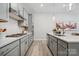 Modern kitchen features gray cabinets, quartz countertops, and stainless steel appliances at 1186 Lost Cove Rd, Indian Land, SC 29707
