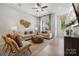 Bright living area with large windows, showcasing a cozy seating arrangement and modern decor at 1186 Lost Cove Rd, Indian Land, SC 29707