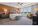 Main bedroom with tray ceiling, large windows, and ensuite bath at 1186 Lost Cove Rd, Indian Land, SC 29707