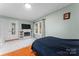 Bedroom with fireplace, hardwood floors, and built-in shelving at 138 Wyanoke Ave, Charlotte, NC 28205