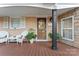 Inviting front porch with wooden deck, wicker chairs, and potted plants at 138 Wyanoke Ave, Charlotte, NC 28205