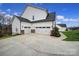 Three-car garage with brick accents and large driveway at 330 Forsythia Ln, Tega Cay, SC 29708