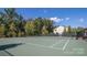 Two well-maintained tennis courts nestled in a wooded area at 330 Forsythia Ln, Tega Cay, SC 29708