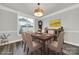 Virtually staged dining room with a wooden table and six chairs at 330 Forsythia Ln, Tega Cay, SC 29708