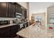 Modern kitchen with dark cabinetry, granite counters, and stainless steel appliances at 4812 Weber Ct, Gastonia, NC 28056