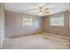 Well-lit bedroom with carpet, ceiling fan and two windows at 5692 Lee Cline Rd, Conover, NC 28613