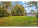 Large backyard with mature trees and home at 627 Brevard St, Statesville, NC 28677