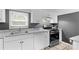 Bright kitchen features white cabinets, granite countertops, and stainless steel appliances at 627 Brevard St, Statesville, NC 28677