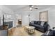 Living room features hardwood floors, a comfy sofa, and a view into the dining area at 627 Brevard St, Statesville, NC 28677