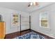 Bright bedroom with two windows, hardwood floors, and a ceiling fan at 627 Brevard St, Statesville, NC 28677