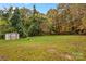 Backyard with shed and overgrown trees at 627 Brevard St, Statesville, NC 28677
