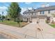 Tan two-story townhome with two-car garage and manicured lawn at 9510 Birkwood Ct, Charlotte, NC 28278