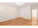 Spacious bedroom with wood flooring and an adjacent door at 9510 Birkwood Ct, Charlotte, NC 28278