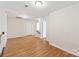 Upstairs hallway with light wood flooring and access to bedrooms at 9510 Birkwood Ct, Charlotte, NC 28278